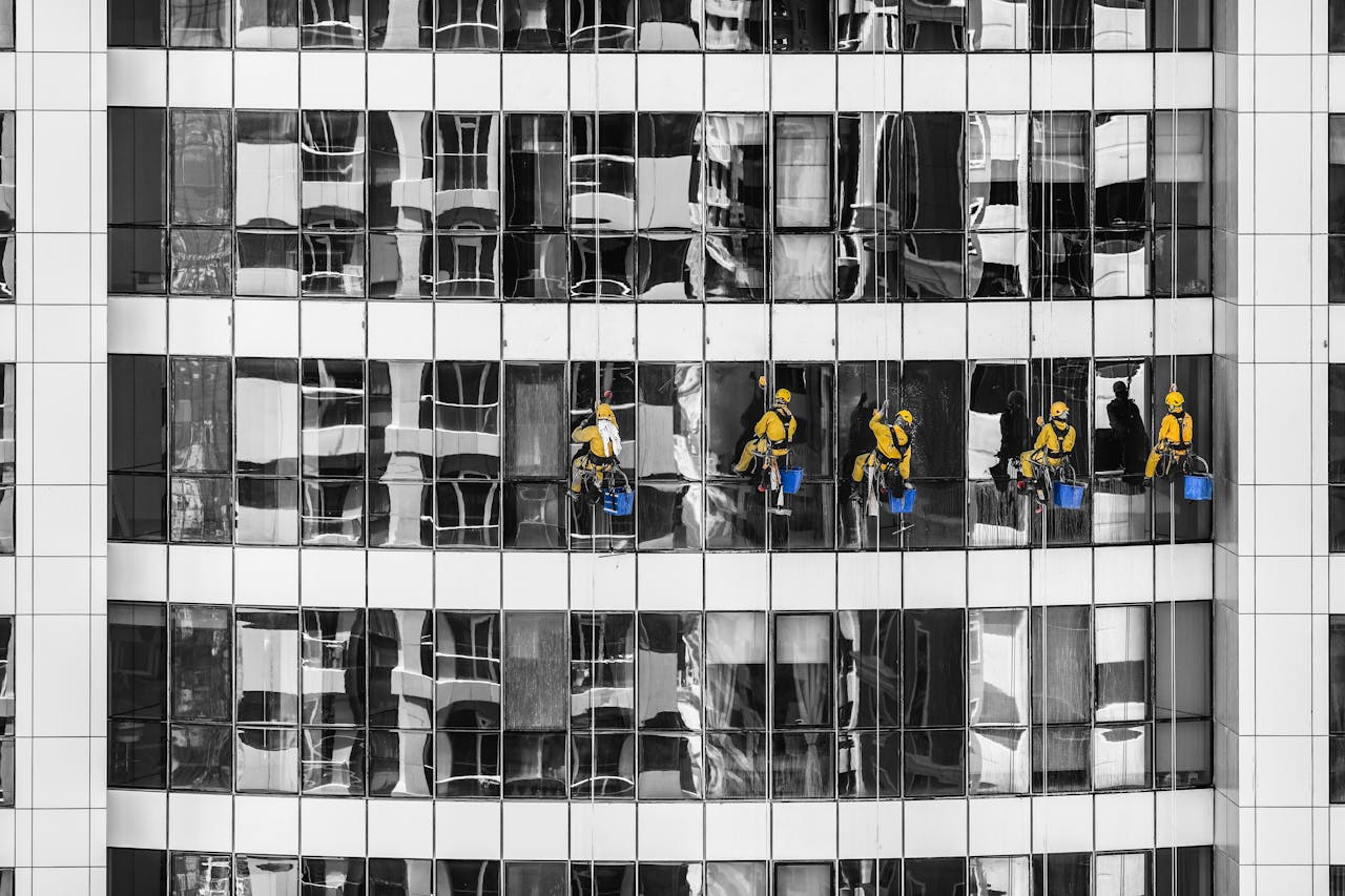 about-us High-rise window cleaners in Dubai cleaning a skyscraper, showcasing urban architecture.
